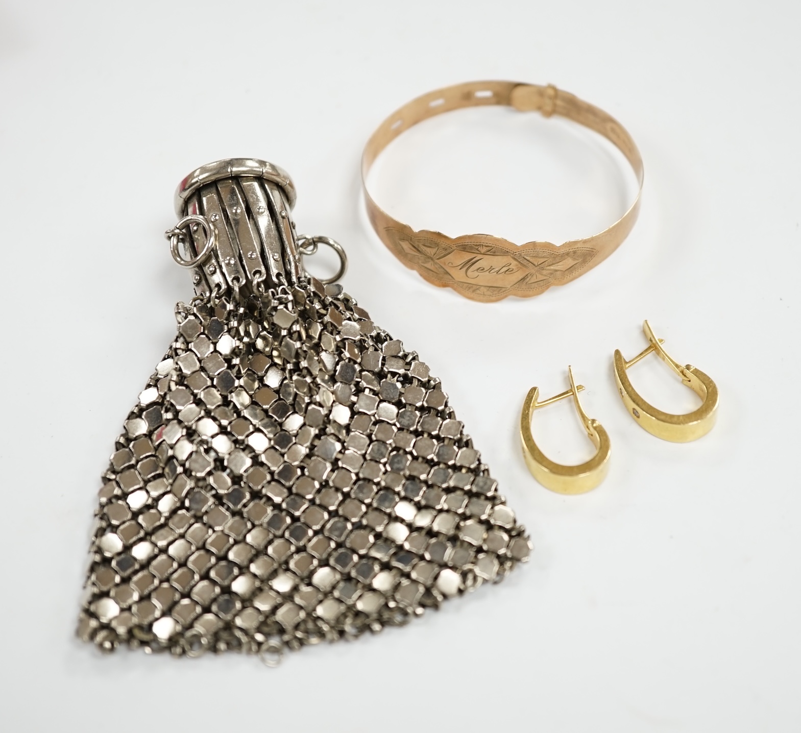 A 9ct gold bracelet inscribed ‘Merle’, a pair of 14k and diamond chip set earrings and an expanding metal purse. Condition - fair